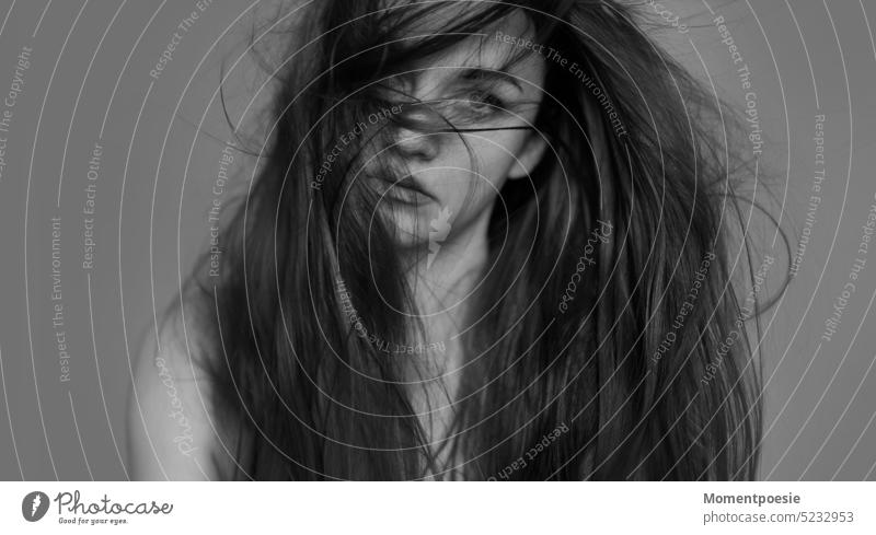 Woman with long hair flying in the wind pretty Black & white photo black-and-white Gray Face of a woman Intensive look eye contact Looking Self-confident timid