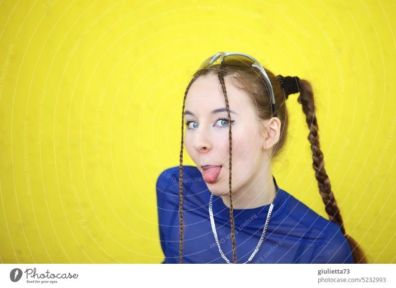 Pretty sassy teen girl with braids and cool techno style sticks her tongue out portrait Human being Caucasian 13 - 18 years 18-20 years 16 17 Puberty plaits