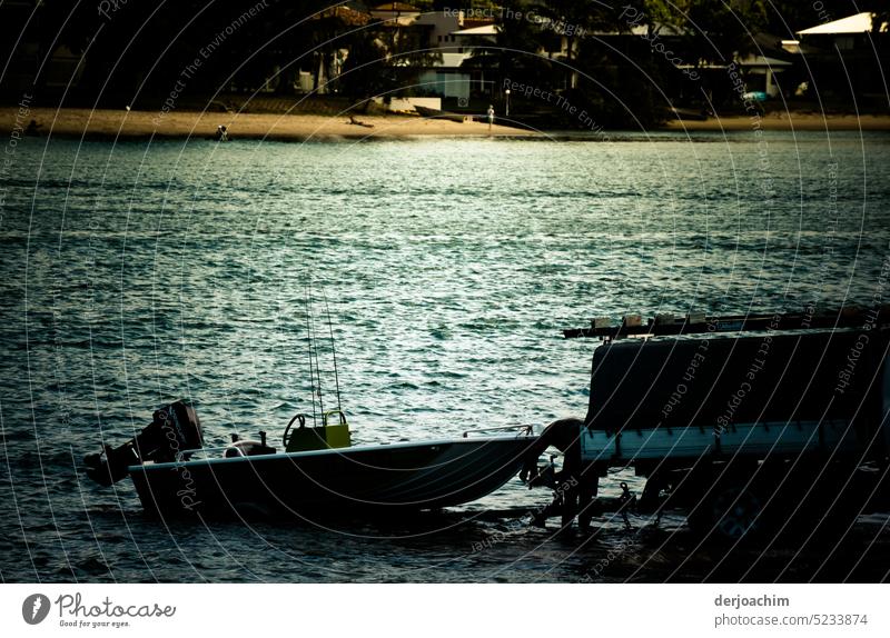 It is evening.  The motorboat is pulled out of the river. It is already coupled to the car. Motorboat Exterior shot Watercraft Boating trip Deserted Sport boats