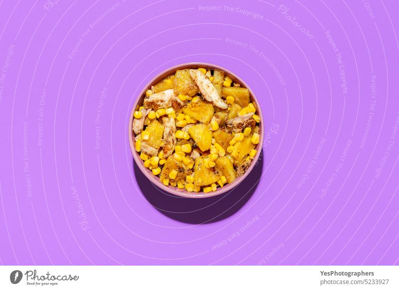 Pineapple chicken salad bowl, above view on a purple background. ananas bright color copy space corn cuisine cut out delicious design diet dish food fried fruit