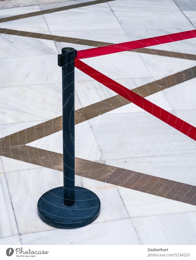 Barrier post with red barrier tape on marble floor with zigzag pattern forms geometric figures Barrier posts Belt post Pillar Red Pattern zig-zag Triangle