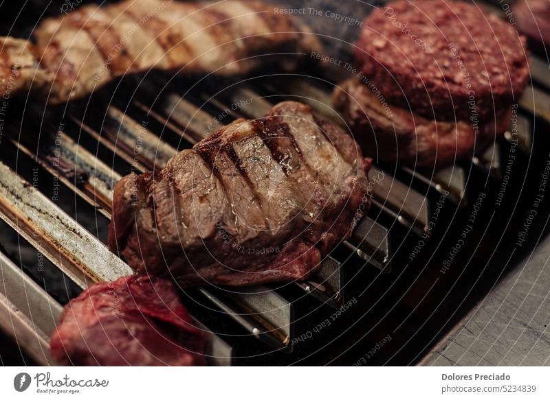 Some excellent pieces of Argentinian beef on a charcoal grill appetizing background barbecue barbeque barbequing bbq bone-in braai closeup cooked cooking