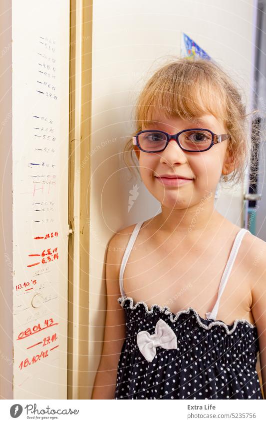 Portrait of sweet little girl with glasses and her height measurements on doorway 7 Adorable Beautiful Care Caucasian Child Childhood Date Dipodic Door