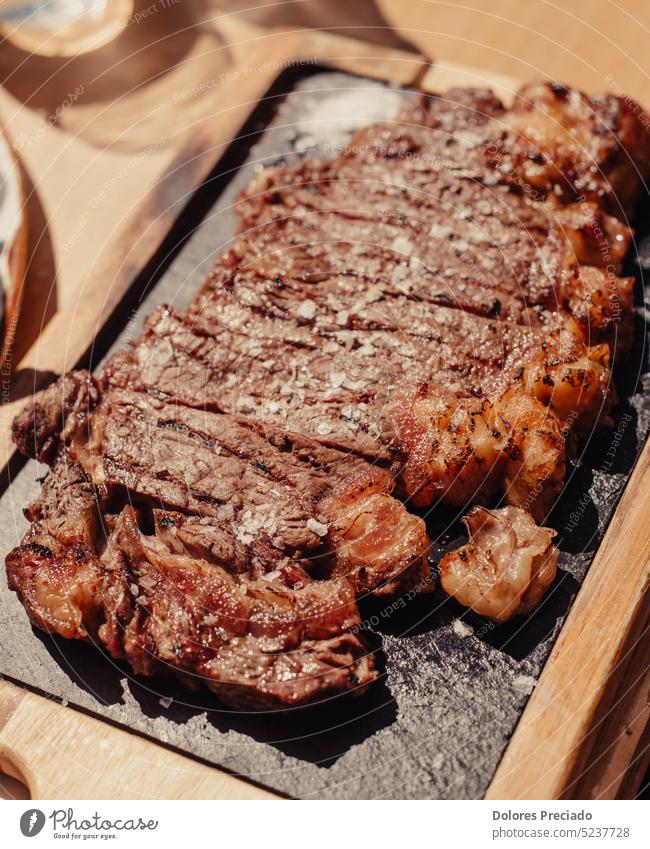 Grilled ribeye steak on wooden board. Grilled meat with sauce. background barbecue barbeque bbq beef beefsteak black cooked cooking cooking background cuisine