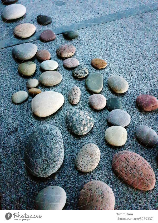 Pebbles collected on the beach rest on the garden table stones Stone Nature Beach Collection Garden table Tabletop shape Light Shadow Denmark
