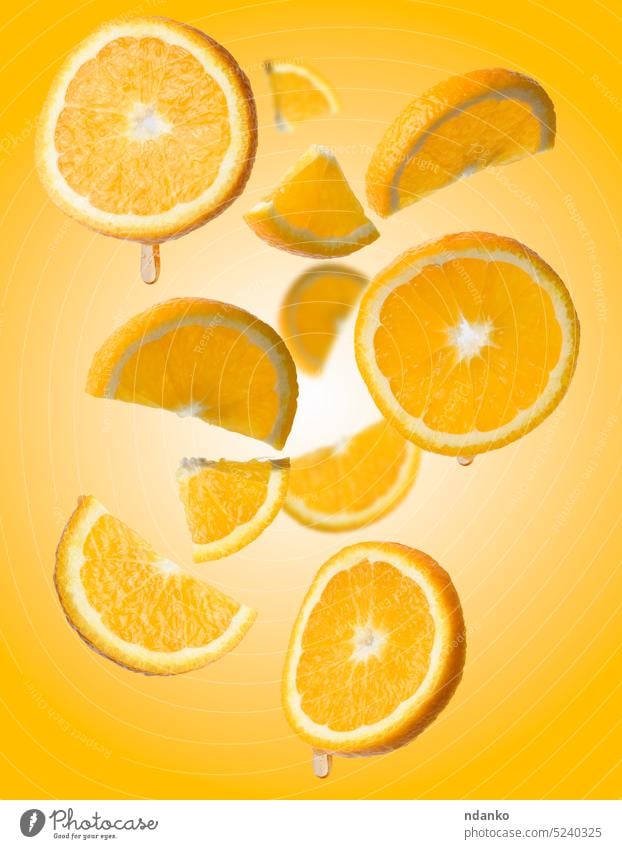 Various pieces of orange levitate on a yellow background, juicy fruit circle citrus raw ripe set slice sliced sweet tropical vegetarian vitamin levitation cut