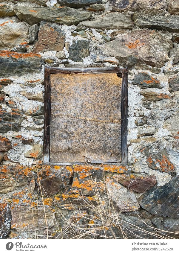temporary closed window in old building Quarrystone facade Natural stones Facade Window Window frame too locked Lichen grasses Dry Old natural-coloured Orange