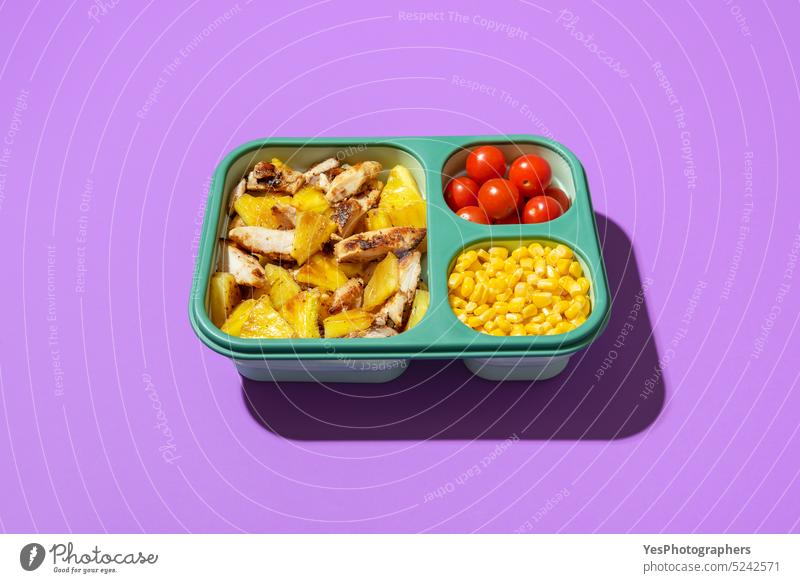Summer salad in a lunch box isolated on a purple background. above bright cherry chicken color container copy space corn cuisine delicious diet dish food fried