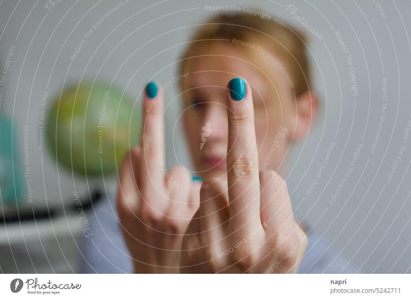 Fuck you. And so much so. | Young woman holds two stretched middle fingers with green painted fingernails into the camera. fuck you Middle finger Anger