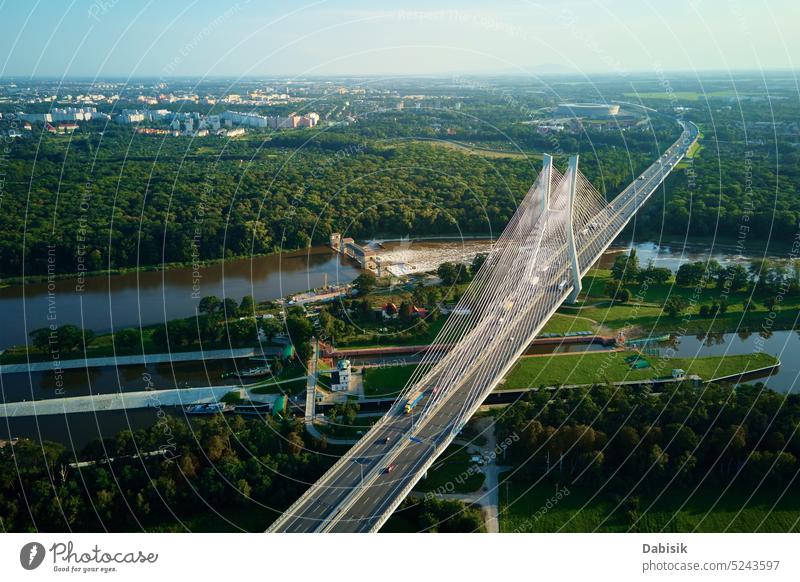 Large cable stayed bridge over river with car traffic, aerial view highway transport city construction transportation poland infrastructure odra wroclaw road