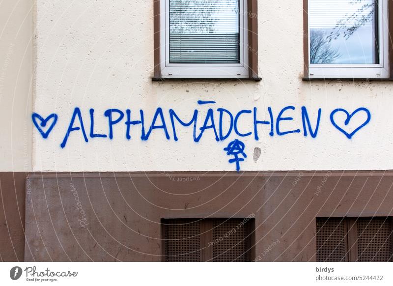 Alpha girl. Graffiti on house wall Alpha Girl Dominant dominate domineering Feminism dominating woman Emancipation Equality enforcement feminist Characters