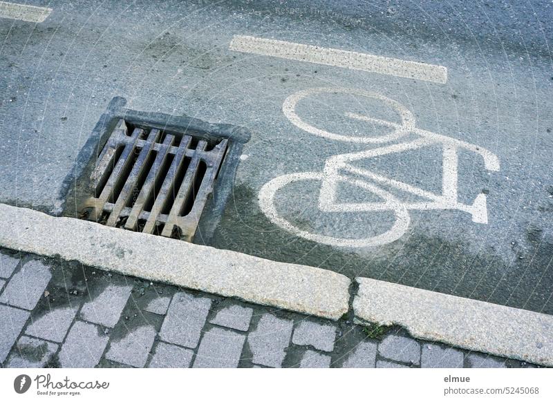 Pictogram of a bicycle next to a manhole cover at the edge of the road / bike lane cycle path Cycle path slop Traffic lane Stumbling block danger spot Footpath