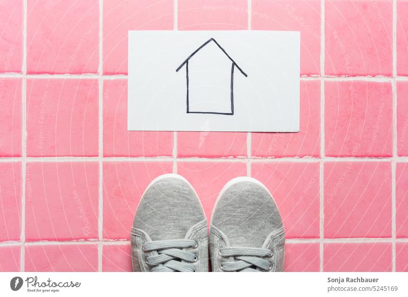 Gray sneakers and an arrow on a notepad. Pink tile floor, top view. Arrow Trend-setting Direction Success pink background tiled floor Future Target Forwards