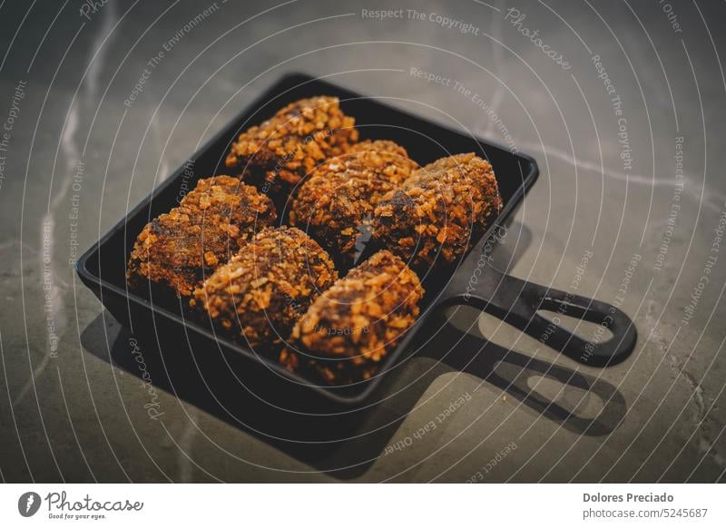 Fried chicken meatballs in a black plate on a marble background asia asian asian foods brown cooking crispy cuisine culture delicious dinner dip dish eating fat