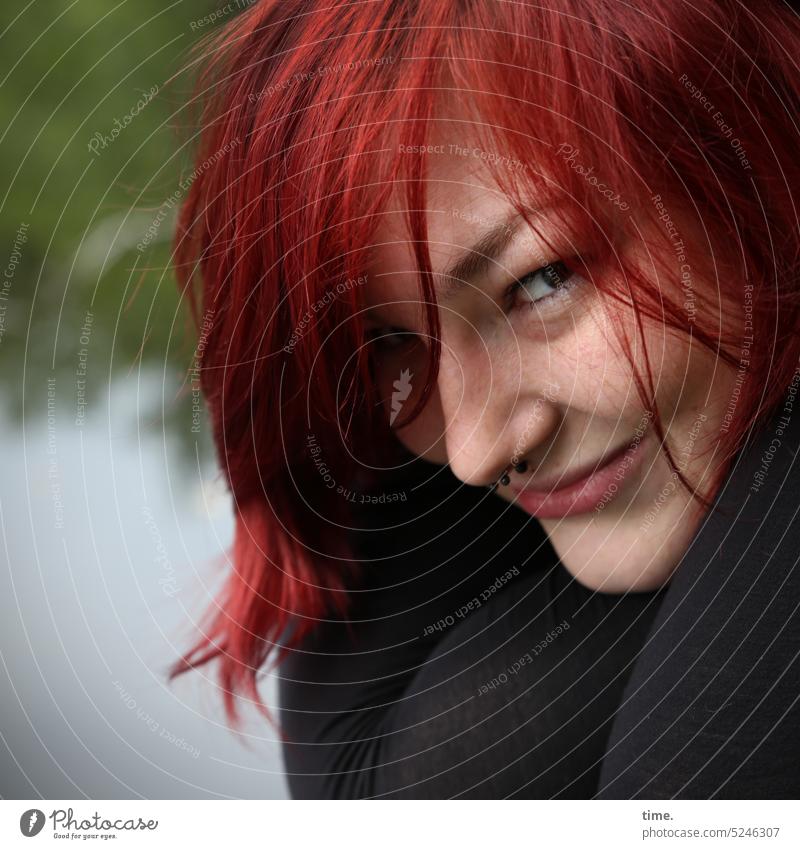 smiling woman at lake Looking Smiling Red-haired Woman feminine Impish Lake Nature Feminine Looking into the camera Face Long-haired Half-profile