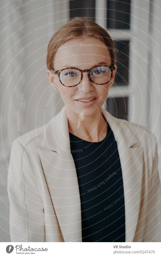 Pretty businesswoman in glasses and office jacket looking at camera. Eyeglass store advertising female eyewear spectacles eyesight portrait fashion model