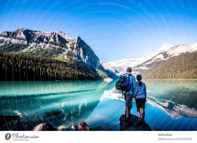 Together in the same direction Lake Louise silent Peaceful Lonely Loneliness in common Sky Love Infancy Child Trip Trust Boy (child) hikers Parents Man Father