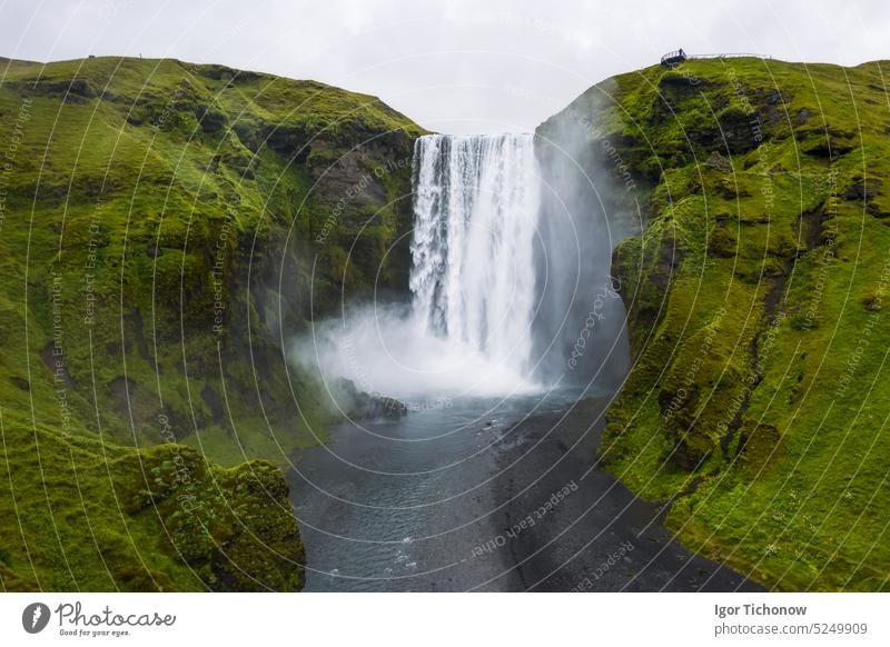 Aerial drone view of Skogafoss waterfall in Iceland, one of the most famous tourist visited attraction and landmark landscape aerial beautiful iceland south