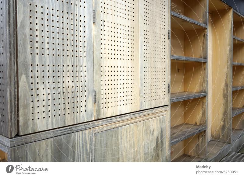 Wooden cladding of a ticket booth with information and empty wooden shelf at shaft XII of Zollverein colliery in Ruhr area in North Rhine-Westphalia in Germany