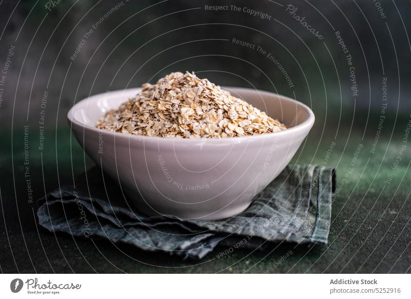 Healthy oatmeal porridge cooking protein bowl concrete food healthy grain ingredient organic raw spoon table nourish dry fiber uncooked breakfast cereal morning