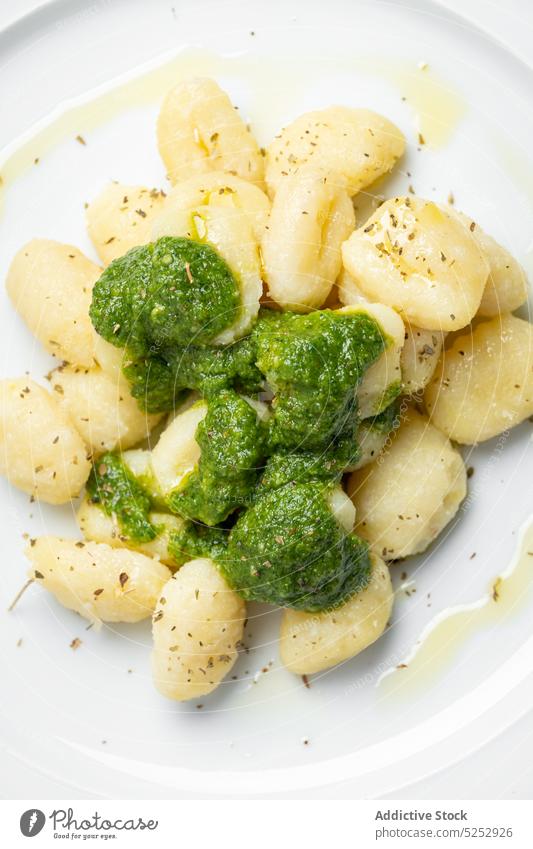 Delicious gnocchi with pesto sauce on plate toast serve portion culinary recipe food rustic table homemade cuisine appetizing kitchen yummy delicious towel