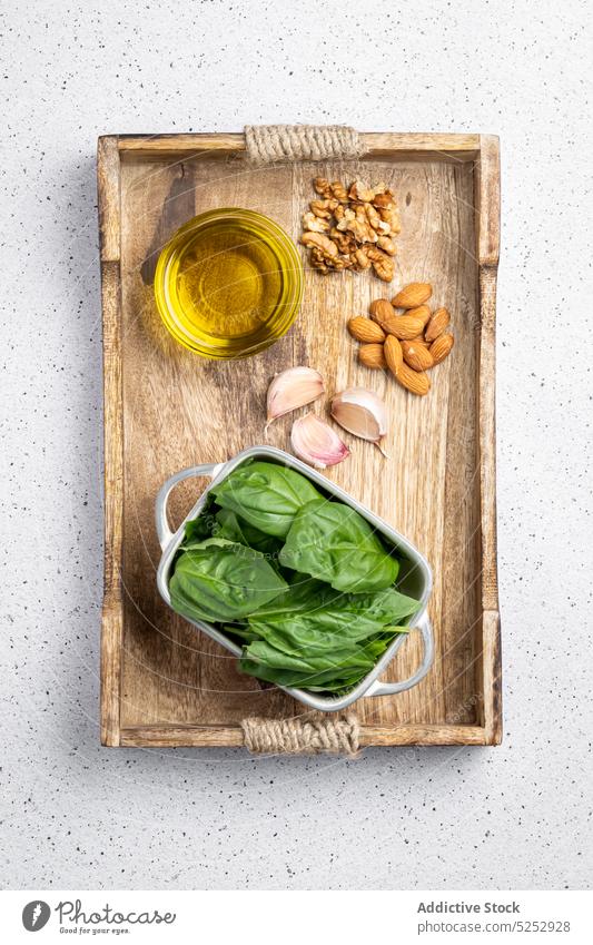 Ingredients for pesto sauce on wooden board ingredient gnocchi garlic oil nut spinach culinary recipe food rustic kitchen delicious table cuisine tradition
