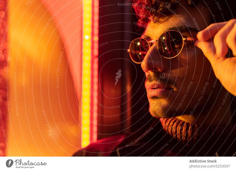 Male in eyeglasses near window at night man appearance contemplate dream thoughtful wistful twilight individuality personality male dusk ethnic curly hair