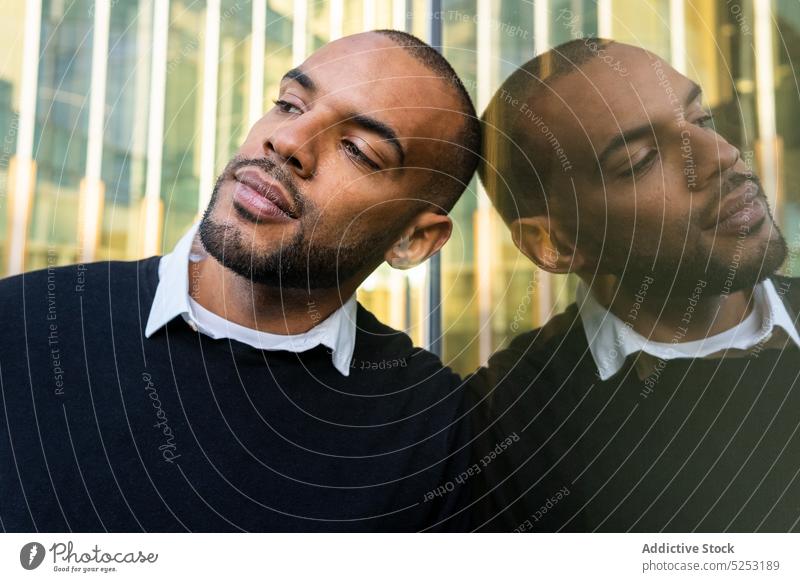 Black businessman leaning on glass wall of office building reflection lean on center respectable street at work confident serious male african american black