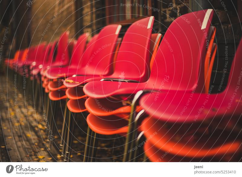 Many red and orange red chairs stacked side by side Seat Row of chairs Places Structures and shapes Event Audience Furniture Theatre Stands Pattern Stack Red