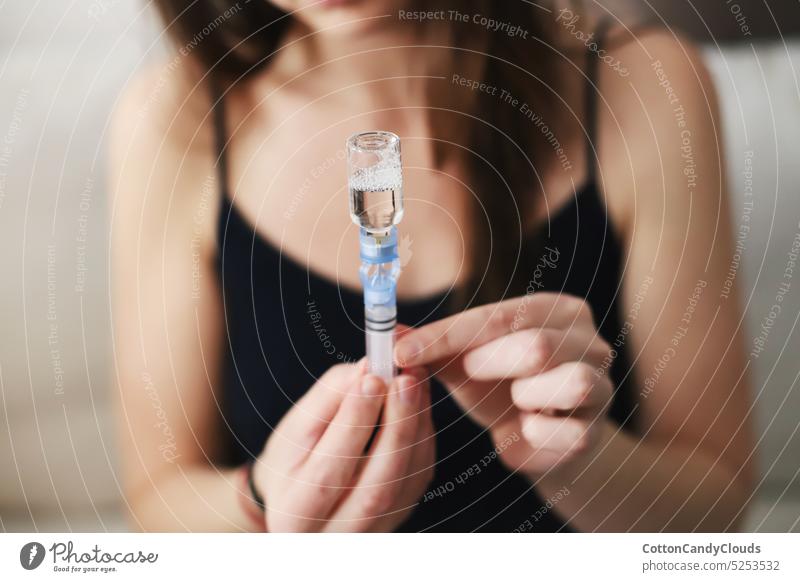 Woman filling up the reservoir of her insulin pump with insulin Filling up Reservoir Insulin pump Type 1 diabetes Diabetes care Medical equipment