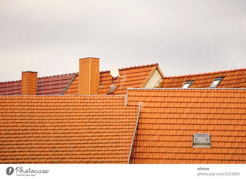 several new tiled roofs with chimneys, skylights and a satellite dish Tiled roof Roof Roofing tile Red Chimney Skylight Satellite Dish house roof Blog dovetail