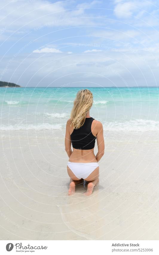 Female in swimwear sitting on beach woman relax harmony ocean sand paradise nature travel vacation australia sea rest tourism female young joy shore water