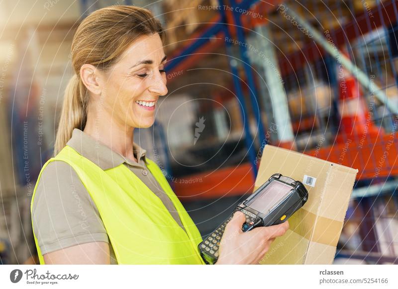 Happy female Worker with barcode scanner, scans bar-code of package, standing at warehouse box freight forwarding happy woman female worker parcel laser scanner
