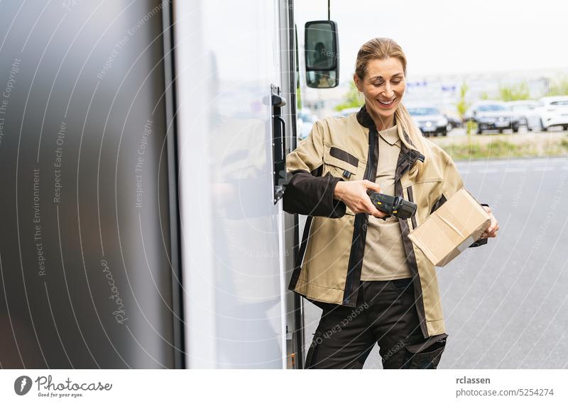female delivery agent scanning barcode with barcode scanner outside of her van on a parcel during his work shift smiling happy service delivery man order mail