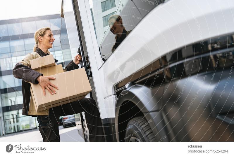 delivery agent holding parcels from a van to deliver it to a customer grab barcode scanner deliveryman smiling happy service order mail storage equipment