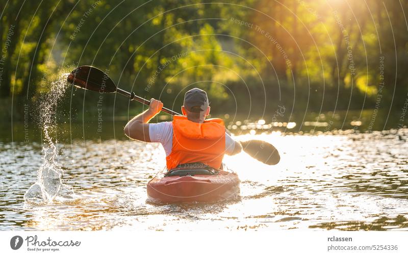 man is kayaking on the river at a summer day island bavaria people outdoor canoe beautiful person sun vacation nature boat exploring sport travel lifestyle