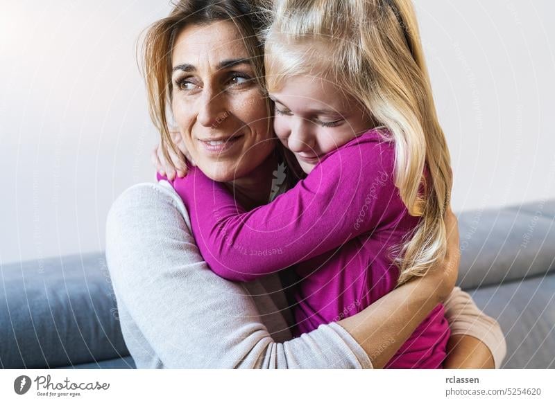 Mother and her daughter child girl playing and hugging. Happy loving family concept image living room sofa mother mom happy kid care woman laugh parent mum love