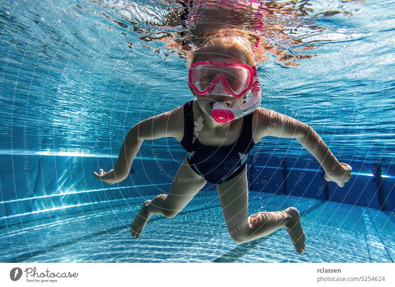 child wearing diving mask swimming in the pool, underwater shot kid childhood kids hotel snorkel dive snorkeling mask water sports thermal resort splash smiling