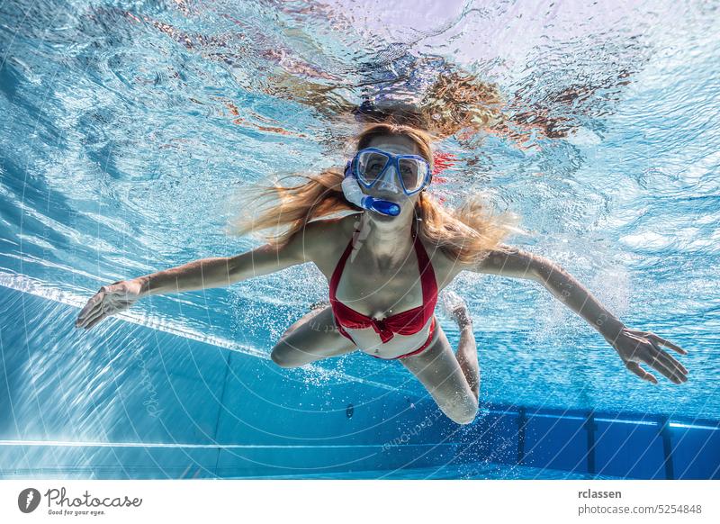 woman in snorkeling mask dive underwater in swimming pool of a Spa Hotel hotel water sports thermal resort splash smiling fashion beautiful young girl hair