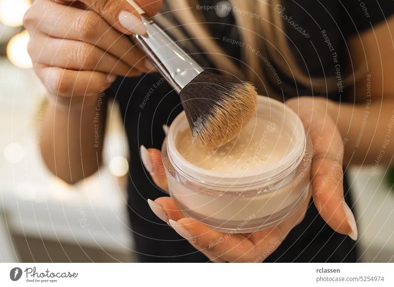 Makeup artist holding powder can with brush for powdering a customer at beauty salon visage leisure service industry makeup artist customer service lifestyle