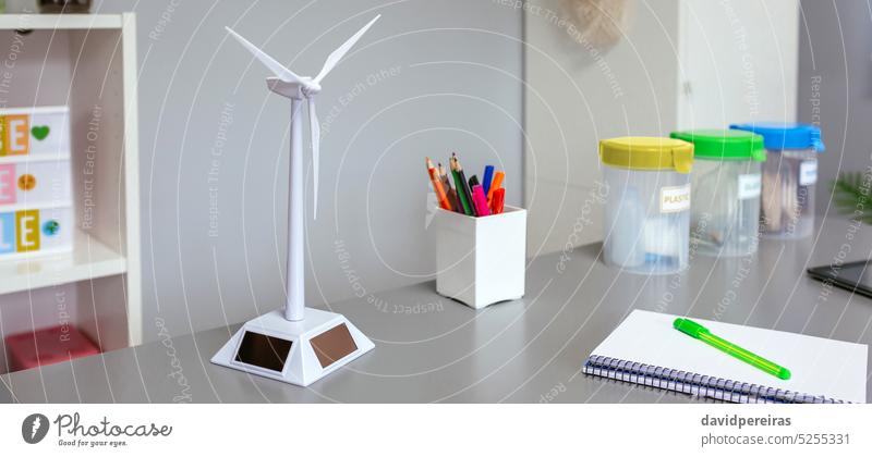 Solar windmill and selective trash bins over desk in classroom ecologic environmental renewable energy panorama panoramic web banner header solar sun ecology