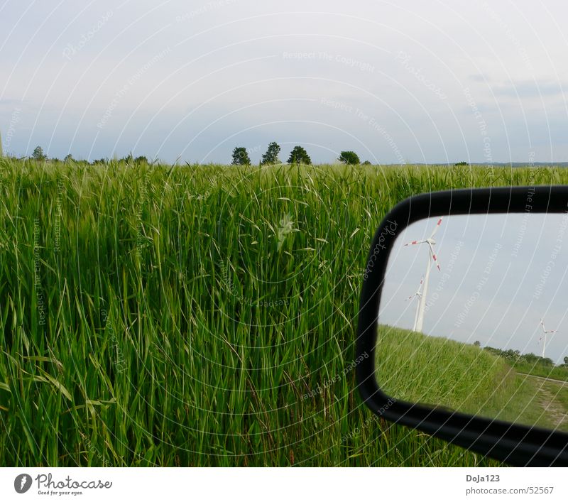 Wind power in the mirror - new energy Field Tree Horizon Clouds Wind energy plant Energy Footpath Grass Mirror Rear view mirror Reflection Stripe Hill Sky