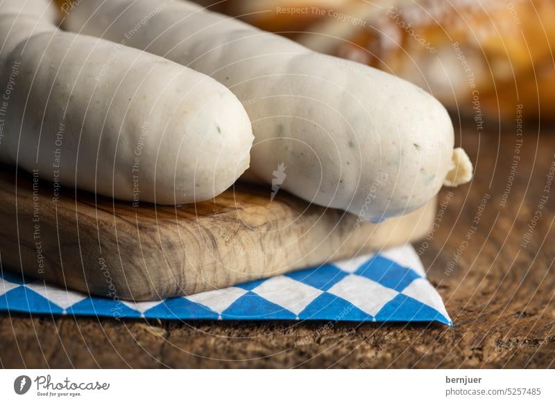 Two Bavarian white sausages on wood Veal sausage Beer Close-up Rustic Eating Tradition Beverage Oktoberfest traditionally Munich festival German biscuits