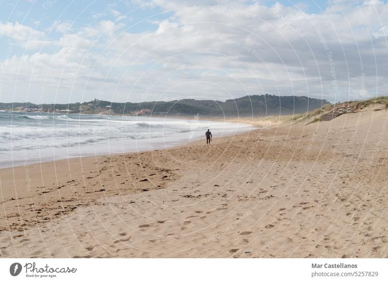 Man walking on the beach in Lanzada beach, Galicia, Spain shore sea coastline seascape surf ocean sand lanscape sumer scenery travel wave sun scenic water