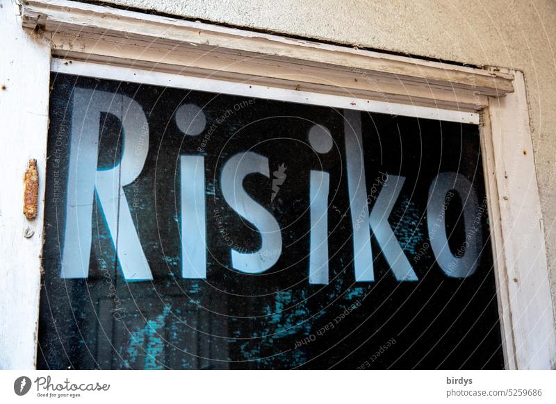 Risk. Font in a window chance risky Word venture Term Printed letters Weathered Dangerous Characters Unpredictable Warn Warning label