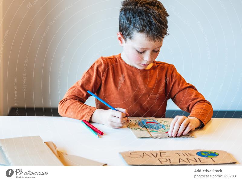 Boy coloring Recycle inscription boy recycle environment classroom placard create child carton table school education cardboard kid creative activist casual