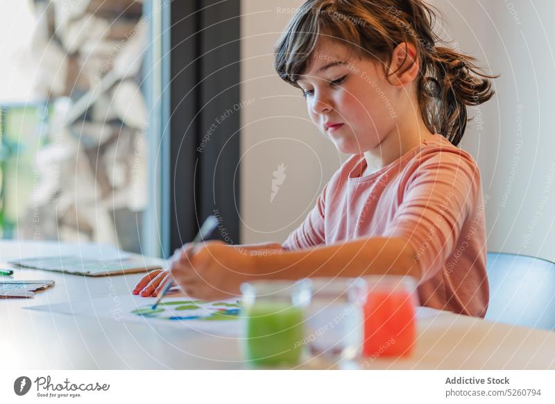 Girl painting environmental banner on paper girl handmade focus creative table earth inspiration paintbrush kid talent poster placard skill pigment child