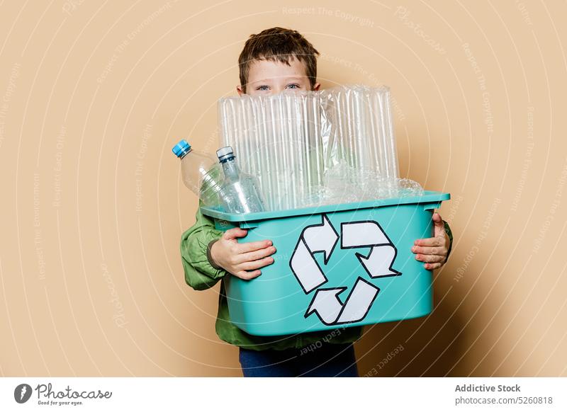 Boy with box recyclable plastic garbage boy carry problem eco friendly environment activist recycle child cute casual kid litter container package adorable