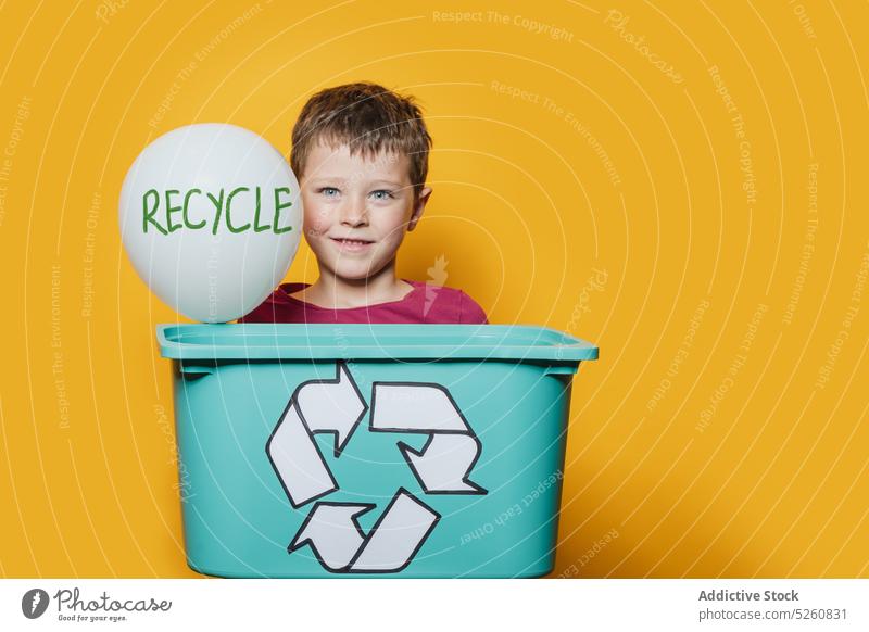Boy with recycling box and balloon boy recycle ecology smile plastic inscription colorful bright kid happy friendly glad symbol occasion rubbish candid child