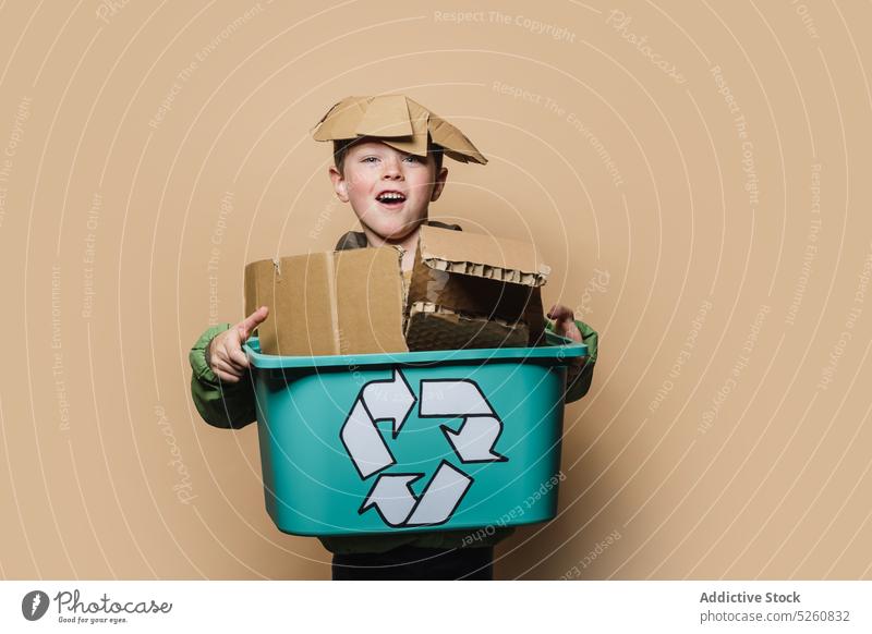 Happy boy with box of carton carry happy recycle environment piece symbol playful kid cardboard paper child sort ecology eco friendly childhood positive
